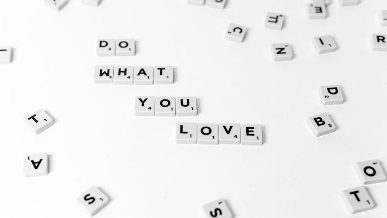 Person holding a smartphone with a 2FA code while logging into a gaming account