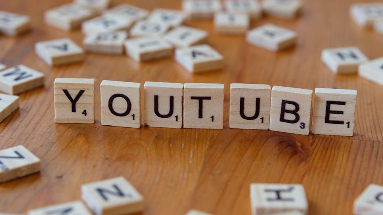 Gamer watching YouTube tutorial on a monitor, focusing intently