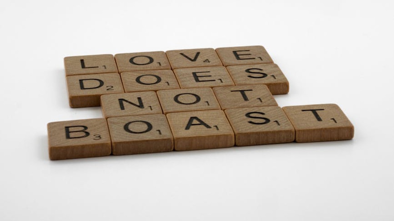 A competitive gamer looking focused during a match, surrounded by gaming peripherals and a vibrant screen.