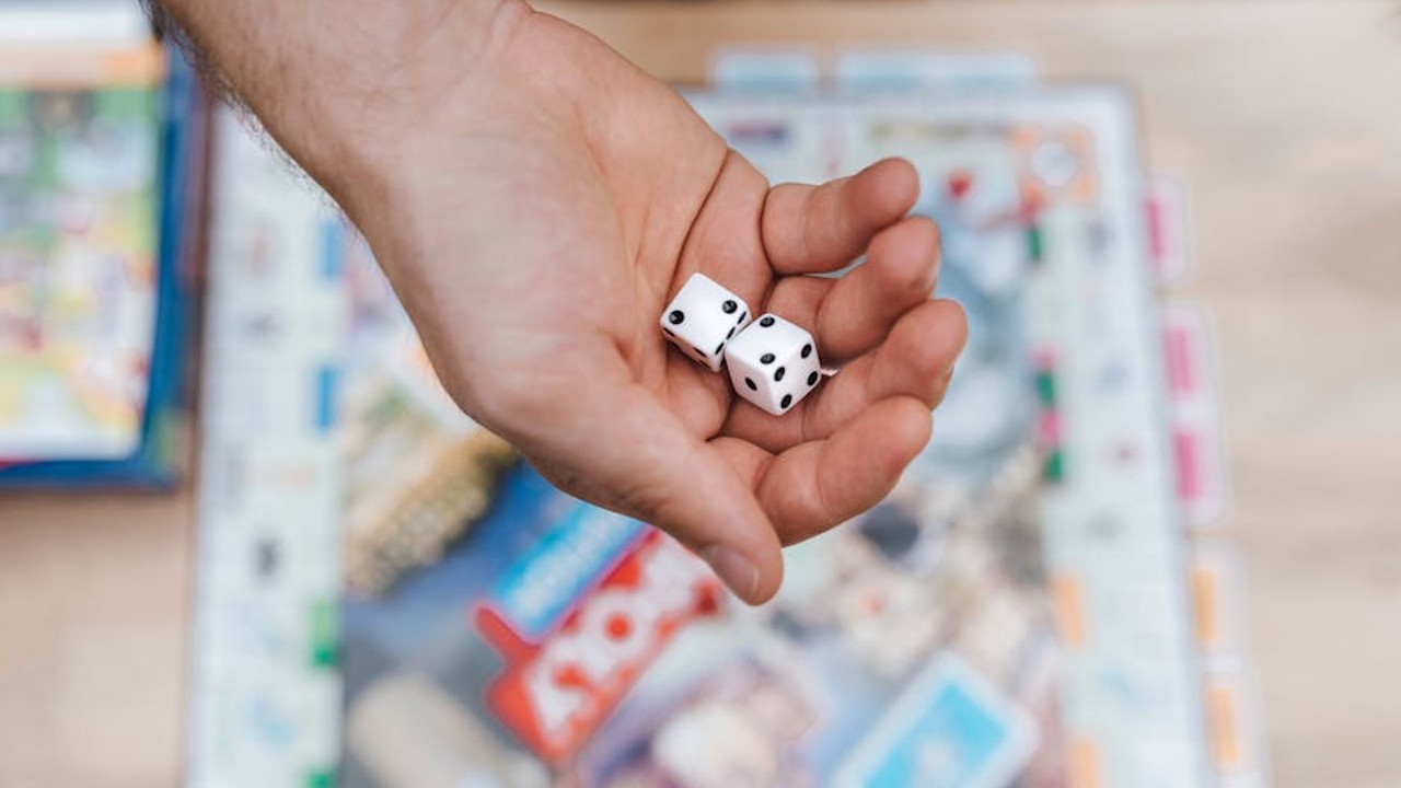 A close-up of a competitive gamer's determined face, bathed in the glow of their monitor.