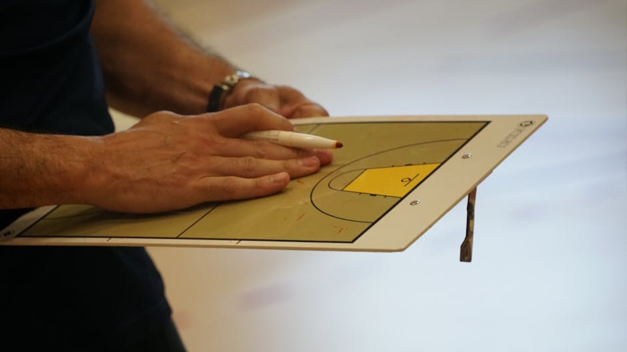 A gaming coach giving encouraging feedback to a student gamer during an online session