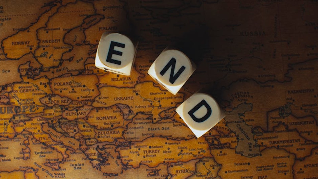 Two hands shaking over a laptop screen displaying a secure online transaction or escrow service, symbolizing a safe deal for a gaming account.