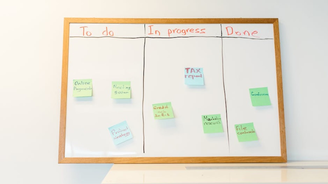 Gamer contemplating strategic decisions on a multi-monitor setup